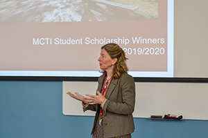 Mary Wells (dean) talks in front of a screen