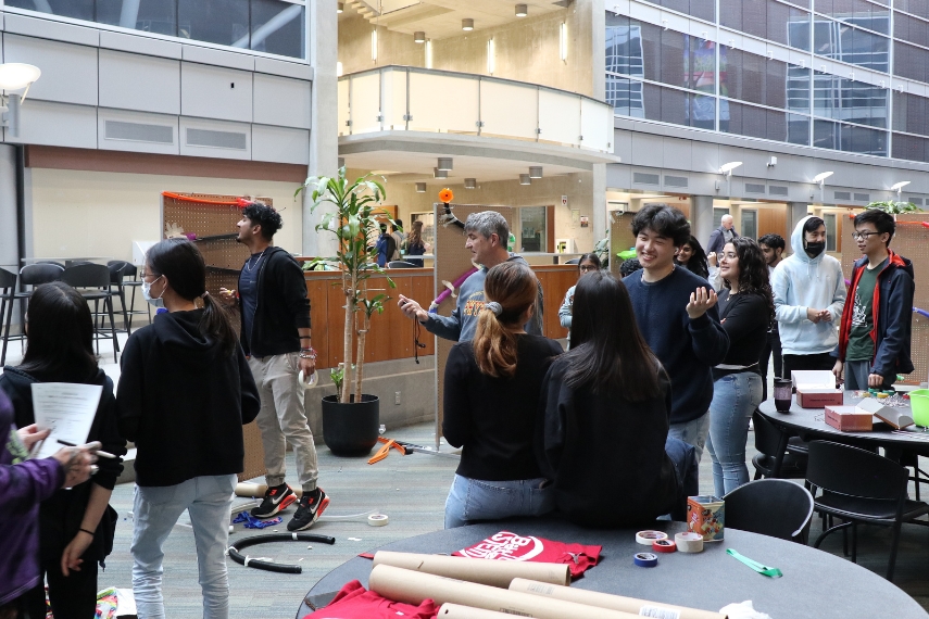 Students gather to observe marble race