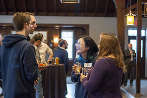 Attendees standing in circle laughing