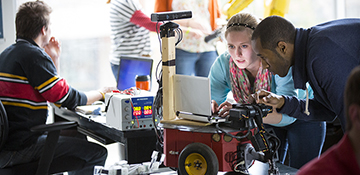 Two engineering students working together on robotics project