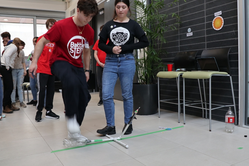 Two volunteers stomp on a rocket device