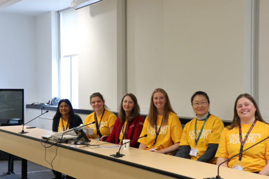 Panel of women in yellow shirts smiling at camera