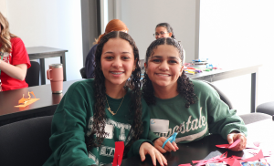 Two attendees smiling at the camera