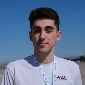 Head shot of Kevin, dark hair wearing whit t-shirt