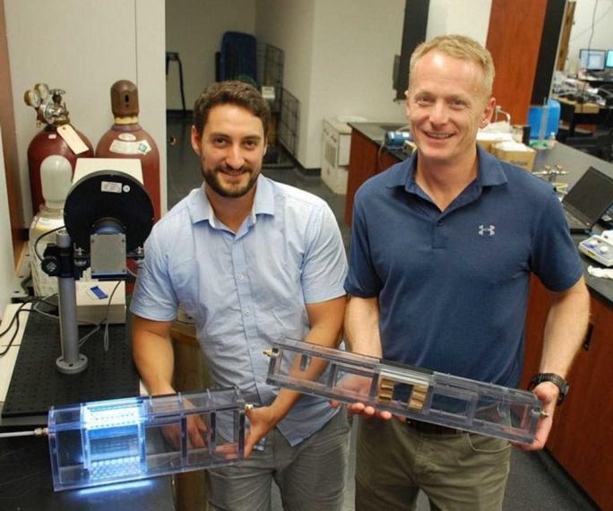 Bill Van Heyst and postdoc David Wood holding prototypes