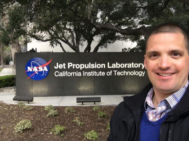 Chris Heirwegh next to NASA sign