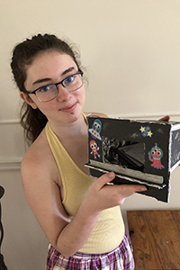 Kiera Lewitzky, grade nine student at John F. Ross Collegiate Vocational Institute, holds a completed Space Exploration kit.