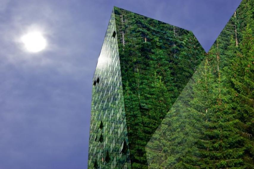 Photo of a set of buildings that show trees reflected in their windows.
