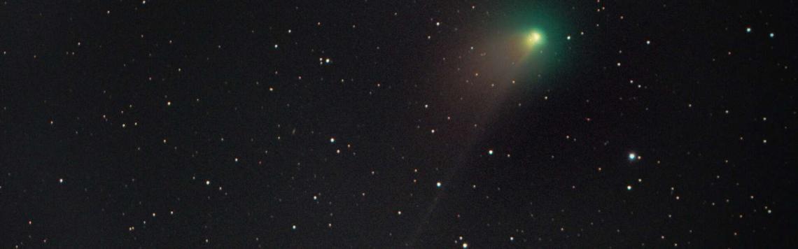 Gallaxy photograph with a green comet