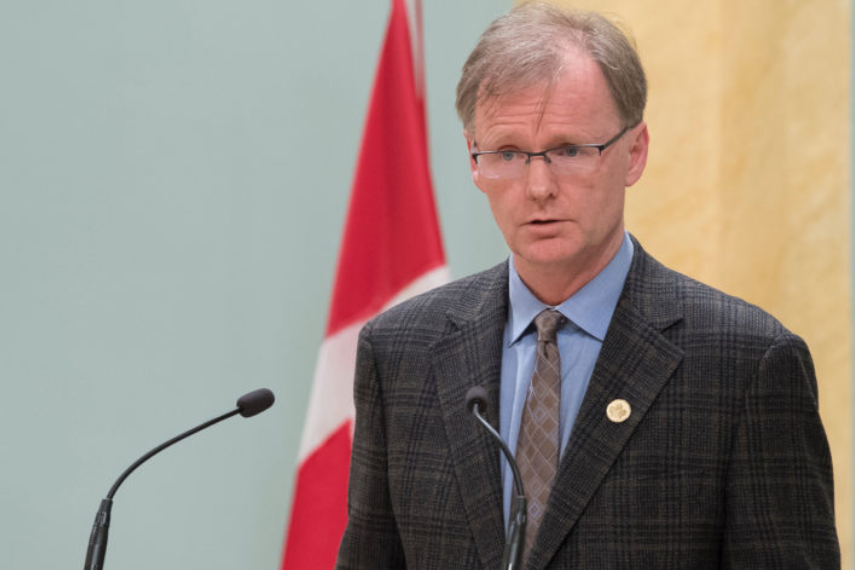 Man speaking at podium and microphone