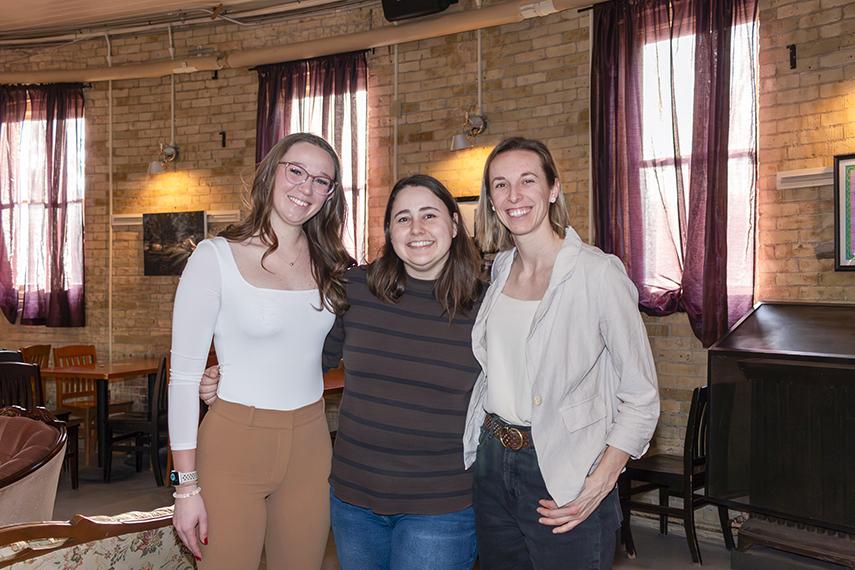 Three women chemists, Emelia, Samantha and Maryanne, stand together smiling in Bullring at U of G.