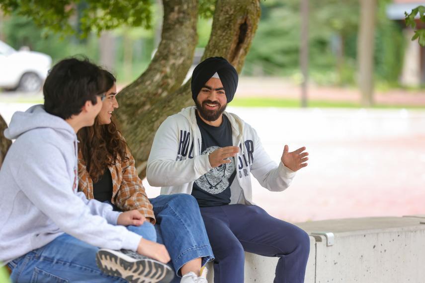 Smaranjeet chats outside at Branion Plaza with two friends. 
