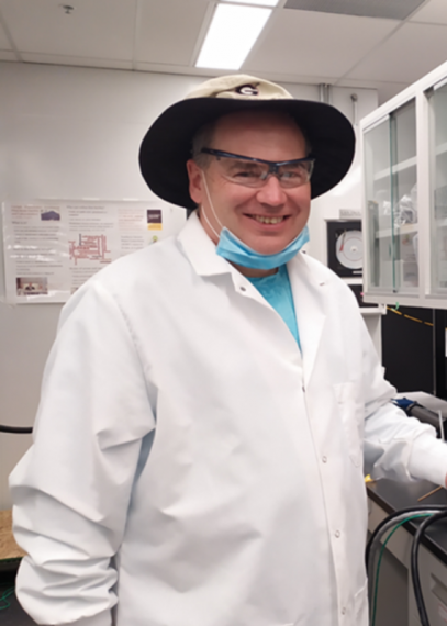 Dr. Kevin Keener in a lab coat and hat in his laboratory
