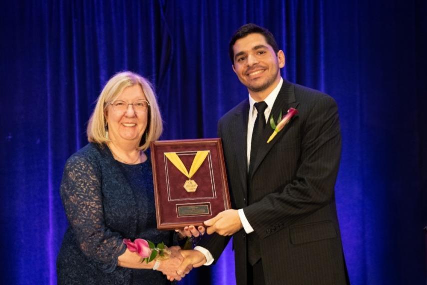 ASM President Dr. Judith Todd presented Dr. Abdallah Elsayed his award at the IMAT Conference in New Orleans