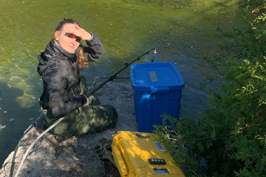 Student in the water with two machines.