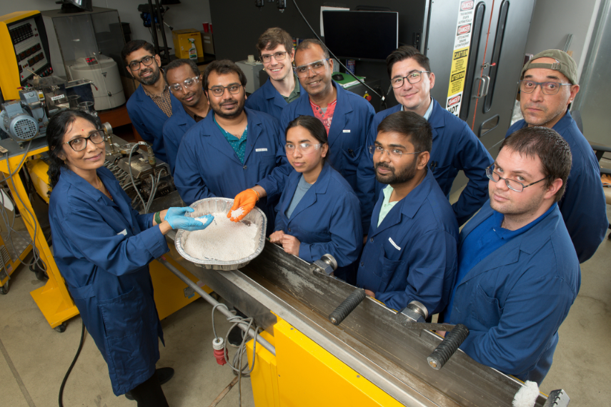 Team of scientists smiling at camera working.