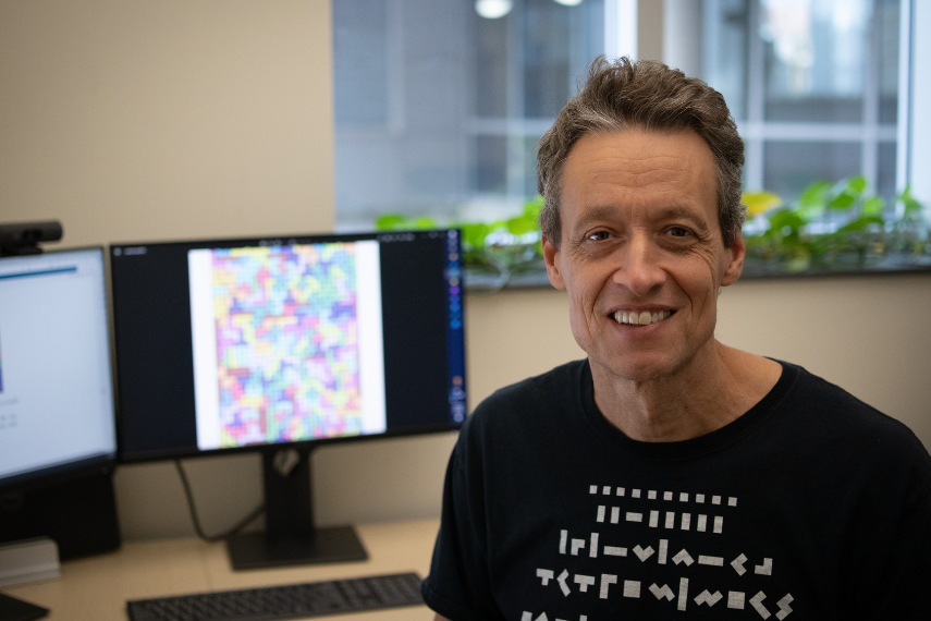 Associate Professor Dr. Garvie sitting in front of his monitor. 