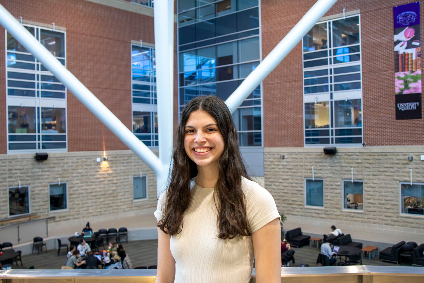 Adele Pinsonneault smiling at camera on SSC second floor.