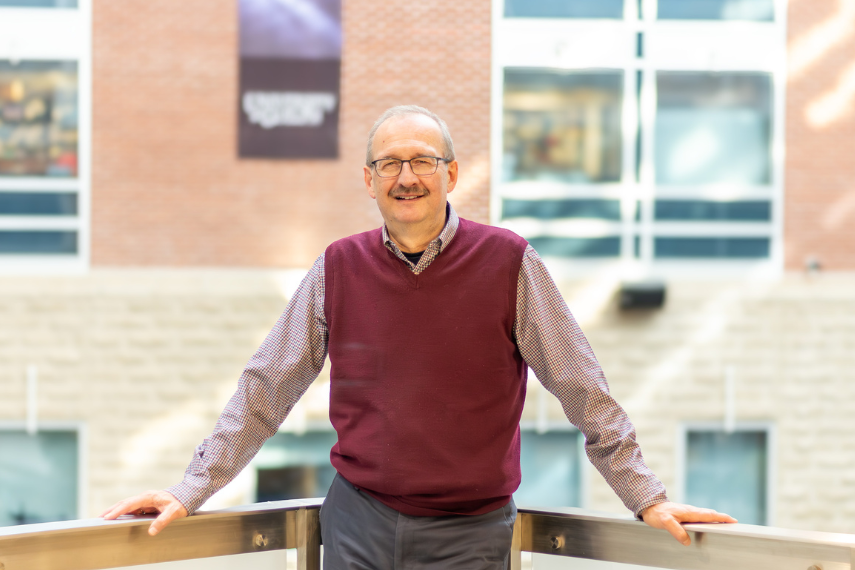 Dean Richard Zytner posing on SSC Atrium balcony. 