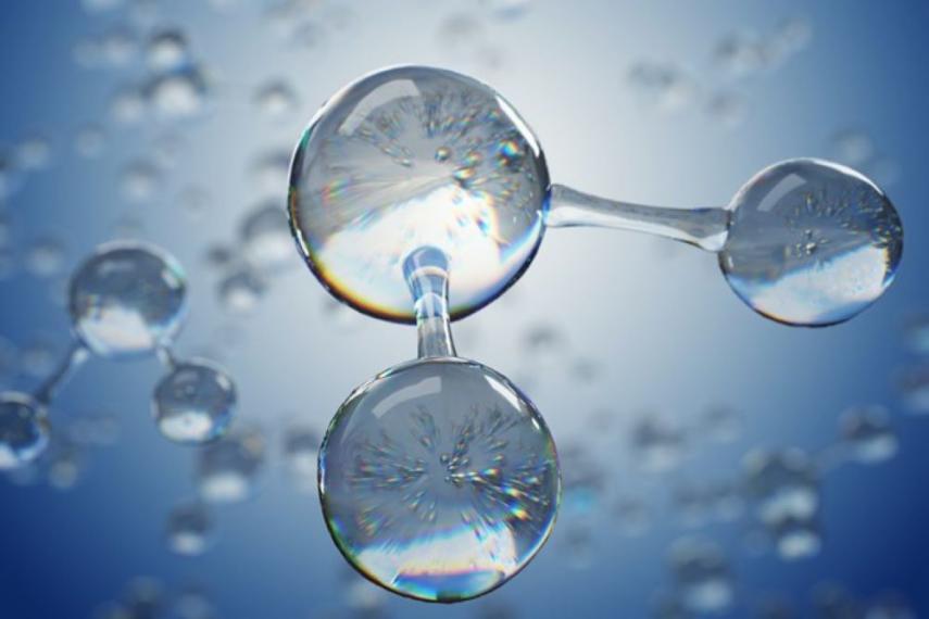 Close-up image of three water droplets in the formation of a water molecule.