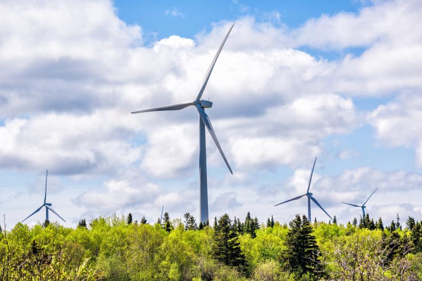 Three wind turbines on a sunny day.