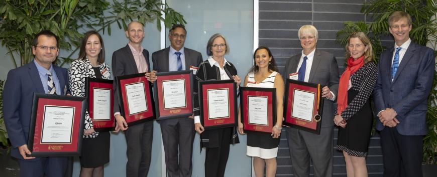 Group of 2019 awards recipients standing together and smiling, holding their awards