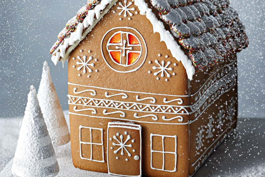 Gingerbread house with mini white trees beside