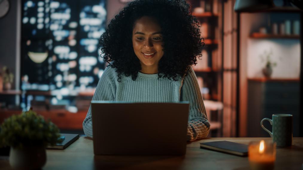 Image of student working on computer in evening