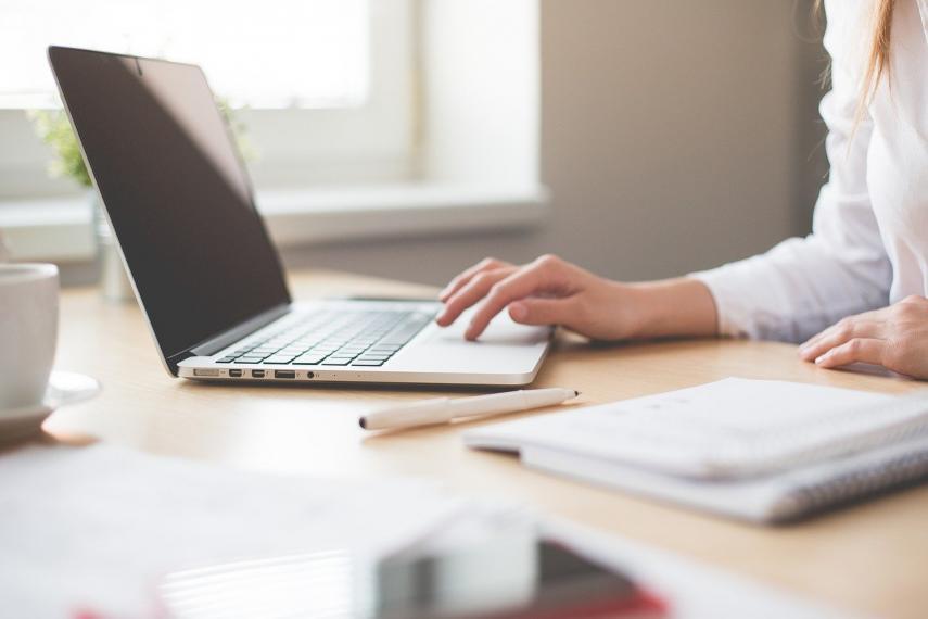 Person sitting at desk on computer