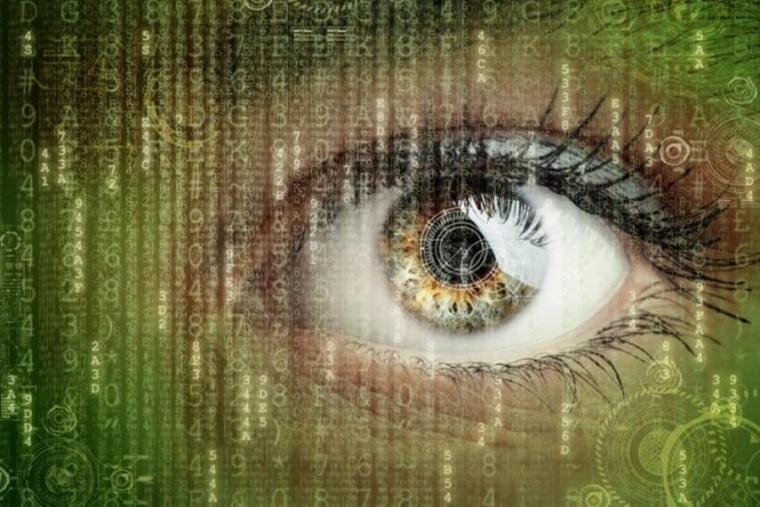 Close-up of eye with computer code overlaid