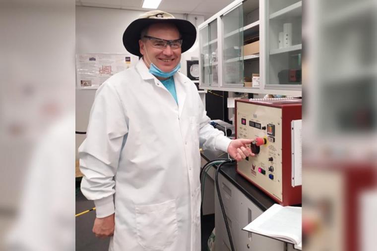 Dr. Kevin Keener standing in laboratory next to a cold plasma generator.