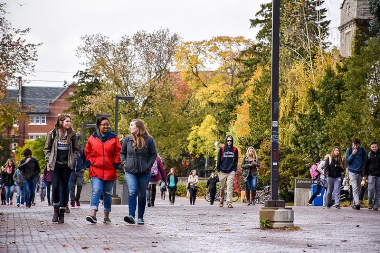 Image of students walking on campus in the fall