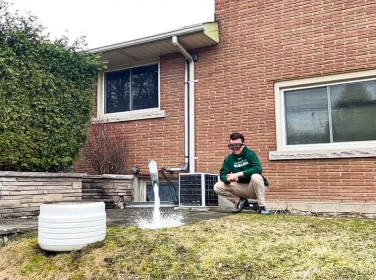 A volunteer from Creative Encounters launches a bottle rocket during Mission STEM-possible.