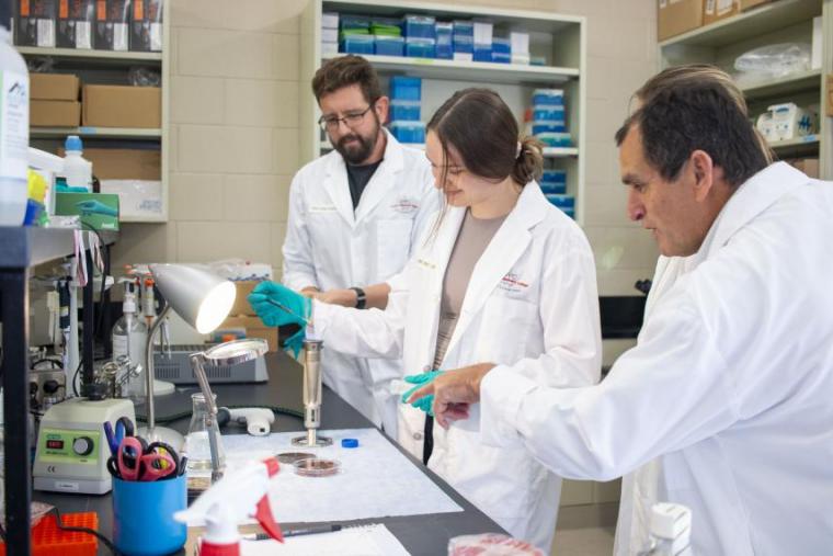 Students and a professor in a lab.