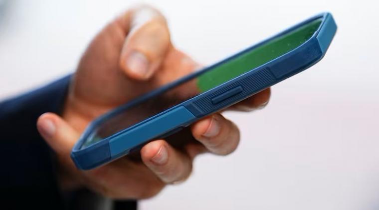 A close-up of a hand holding a smartphone.