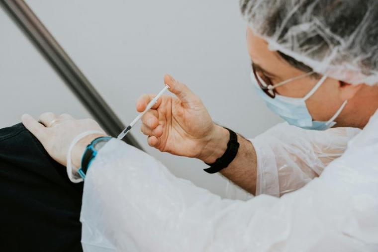 Doctor giving a vaccine.