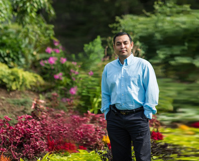 Dr. Animesh Dutta standing in a garden.