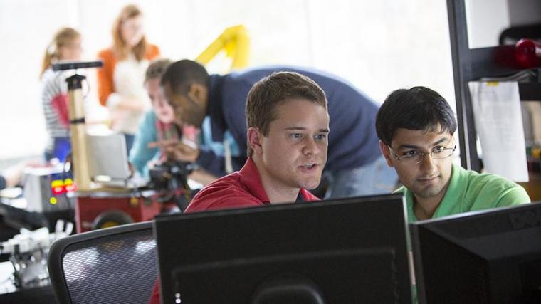 Image of students looking at computer screen