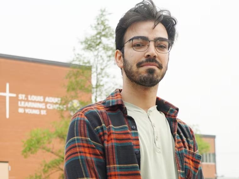Armin Alipour stands outside of the Saint Louis Adult Learning and Continuing Education Centre in Kitchener