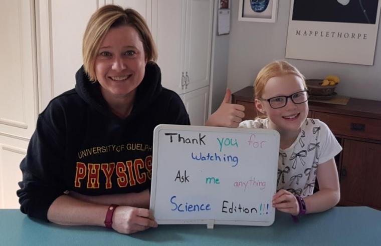 Women and daughter are smiling holding a white board that reads " Thank you for watching Ask me anything Science edition"