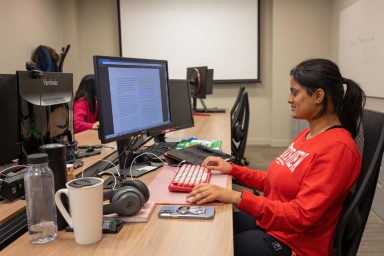 Keerthana sitting at computer