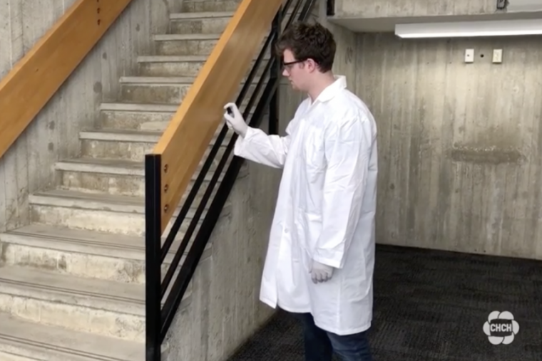 Person spraying bannister of U of G stairwell