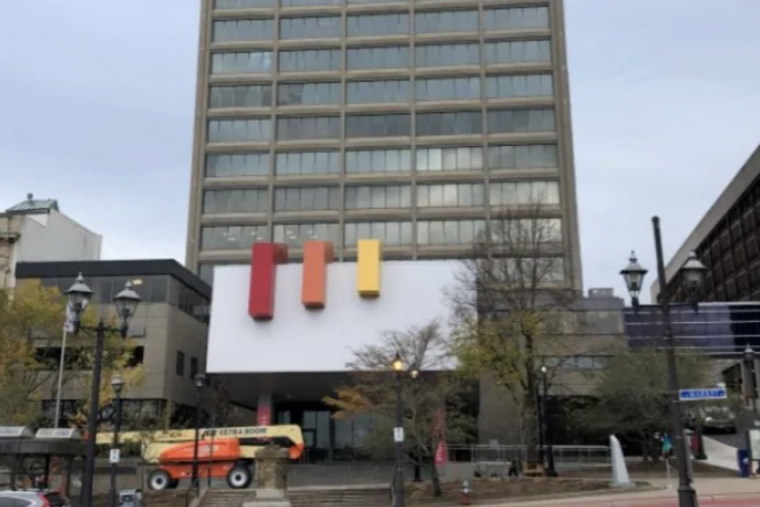 Image of buildings in Saint John with traffic out front