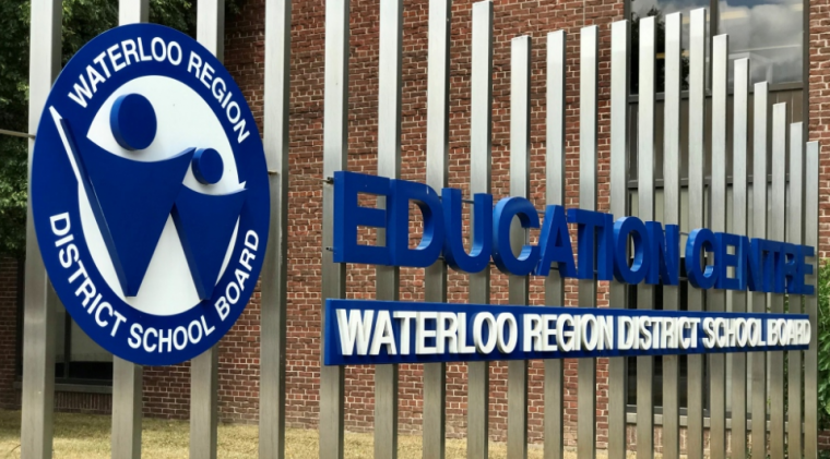 Image of a fence with the words "EDUCATION CENTRE, WATERLOO DISTRICT SCHOOL BOARD"