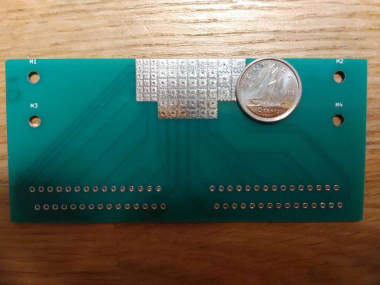 The microfluidic device, with a dime for scale.