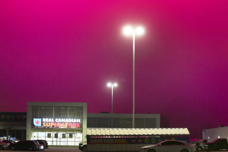 Image of outside of Real Canadian Superstore with Magenta coloured sky. 