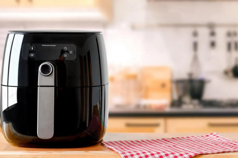 Stock image of air fryer on kitchen counter. 