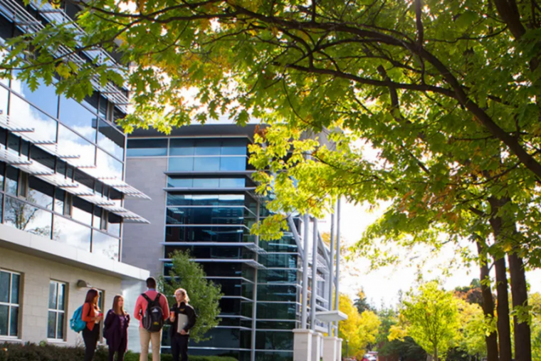 U of G campus with people talking on the left side.