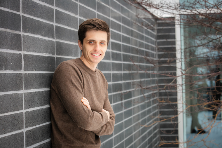 Headshot of Dr. Justin Slater with his arms crossed, smiling at the camera. 