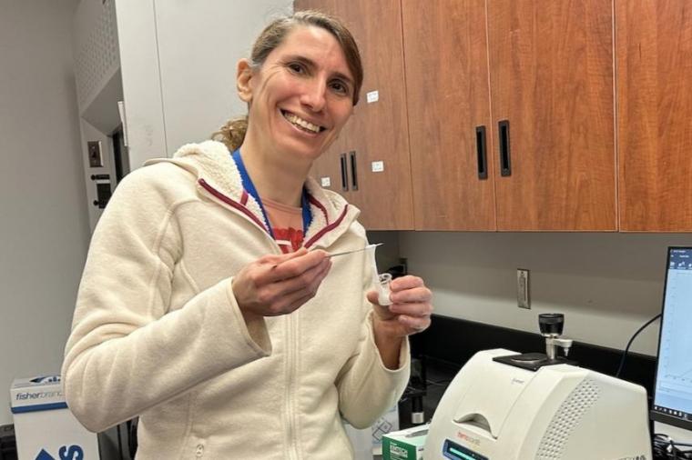 Dr. Erica Pensini in her lab holding up the slime.